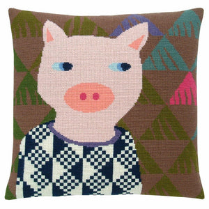 Cross stitch cushion cover with a pig wearing a jumper on a background of brown, green, teal, pink and purple triangles.