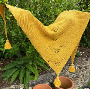 a yellow garter stitch shawl with a lace panel up the centre in BC Garn Summer in Kashmir a sport weight cotton cashmere blend yarn 